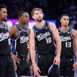 Sacramento Kings guard Malik Monk (0) and guard De'Aaron Fox (5) and forward Domantas Sabonis (10) and forward Keegan Murray (13) look on during a free throw during the fourth quarter against the Toronto Raptors at Golden 1 Center.