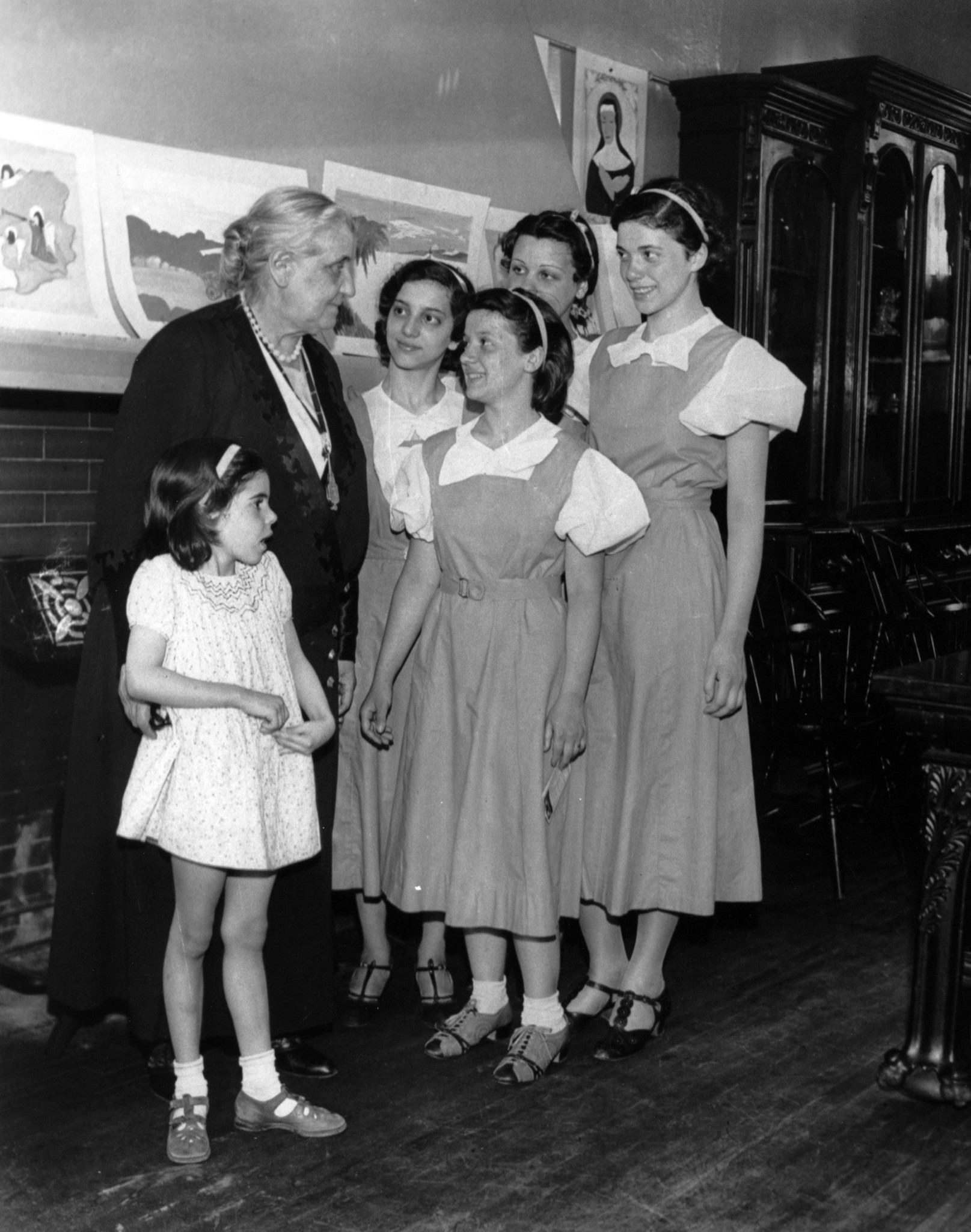 Jane Addams poses with some of her young visitors at...