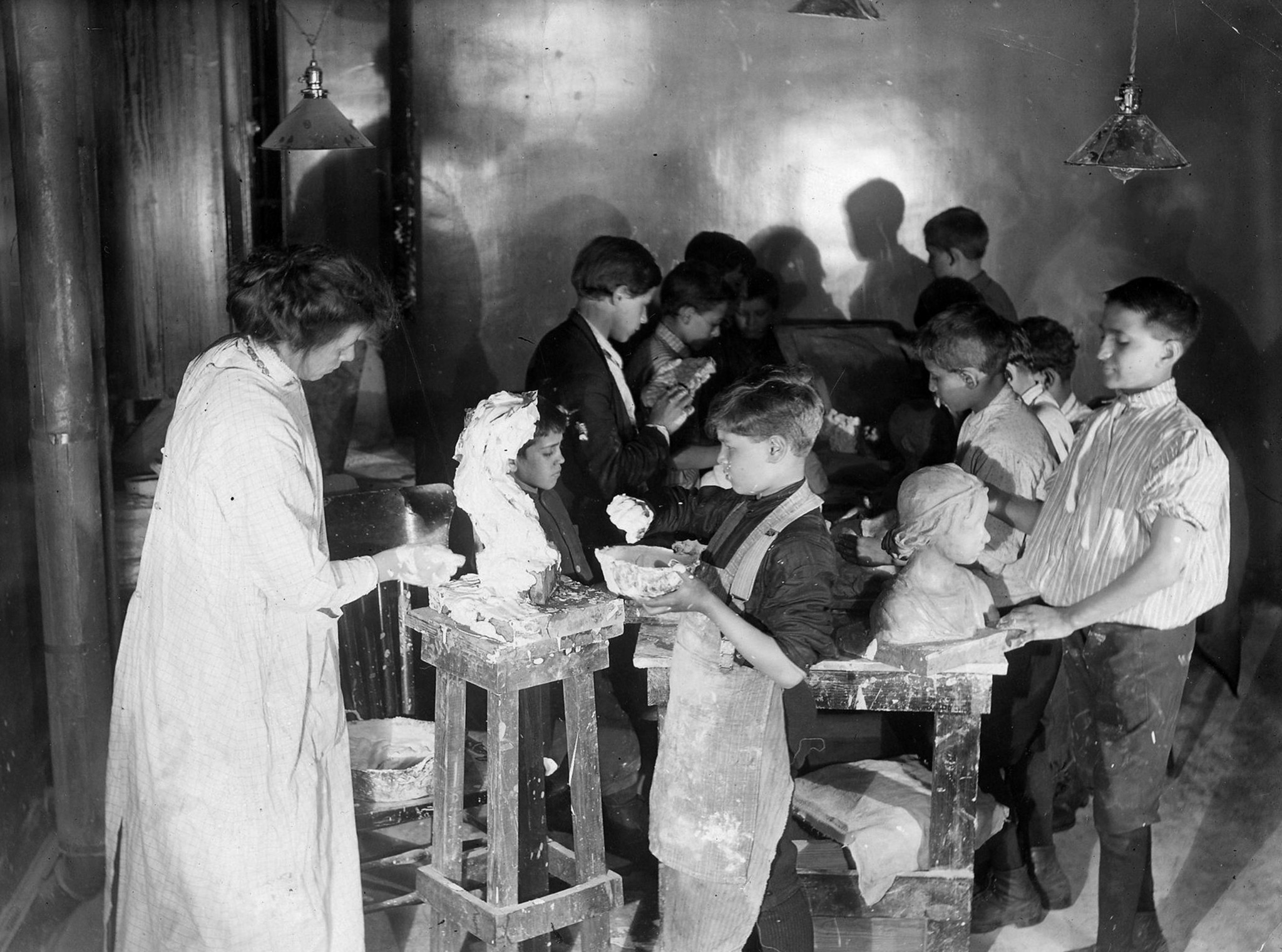 Children work in an art class at Hull House in...