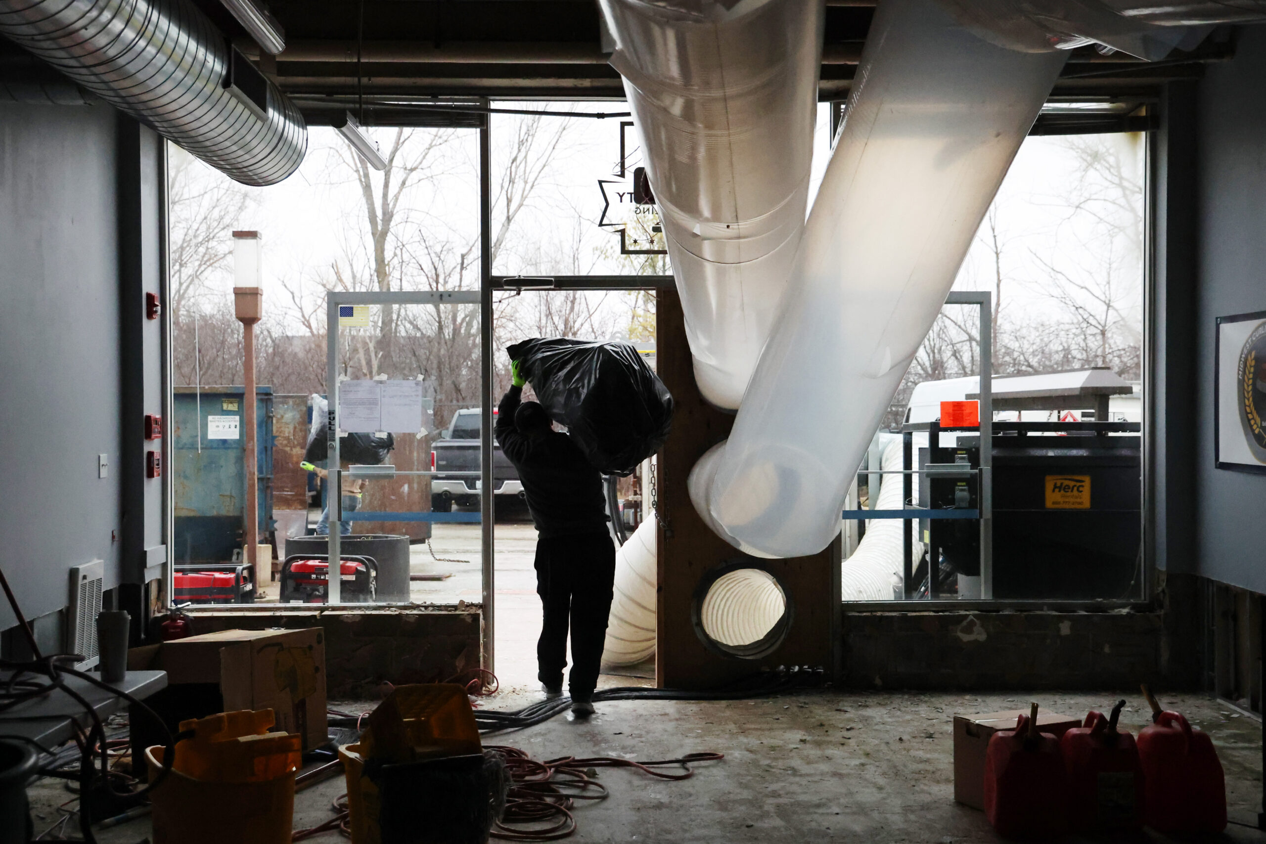 Workers clean up damage at Windy City Curling Club on...