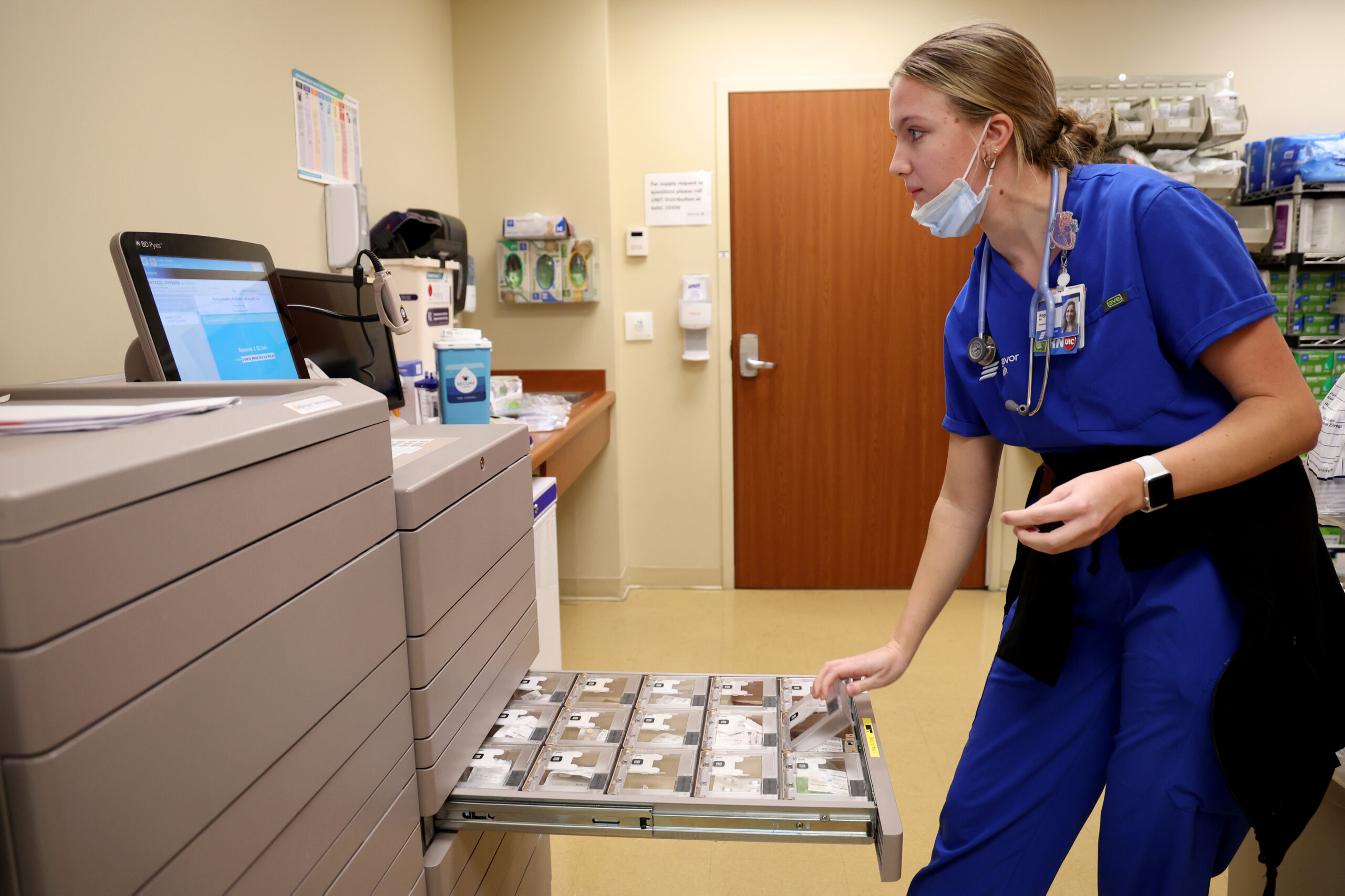 Registered nurse Regan Sauer gets medication for a patient at...