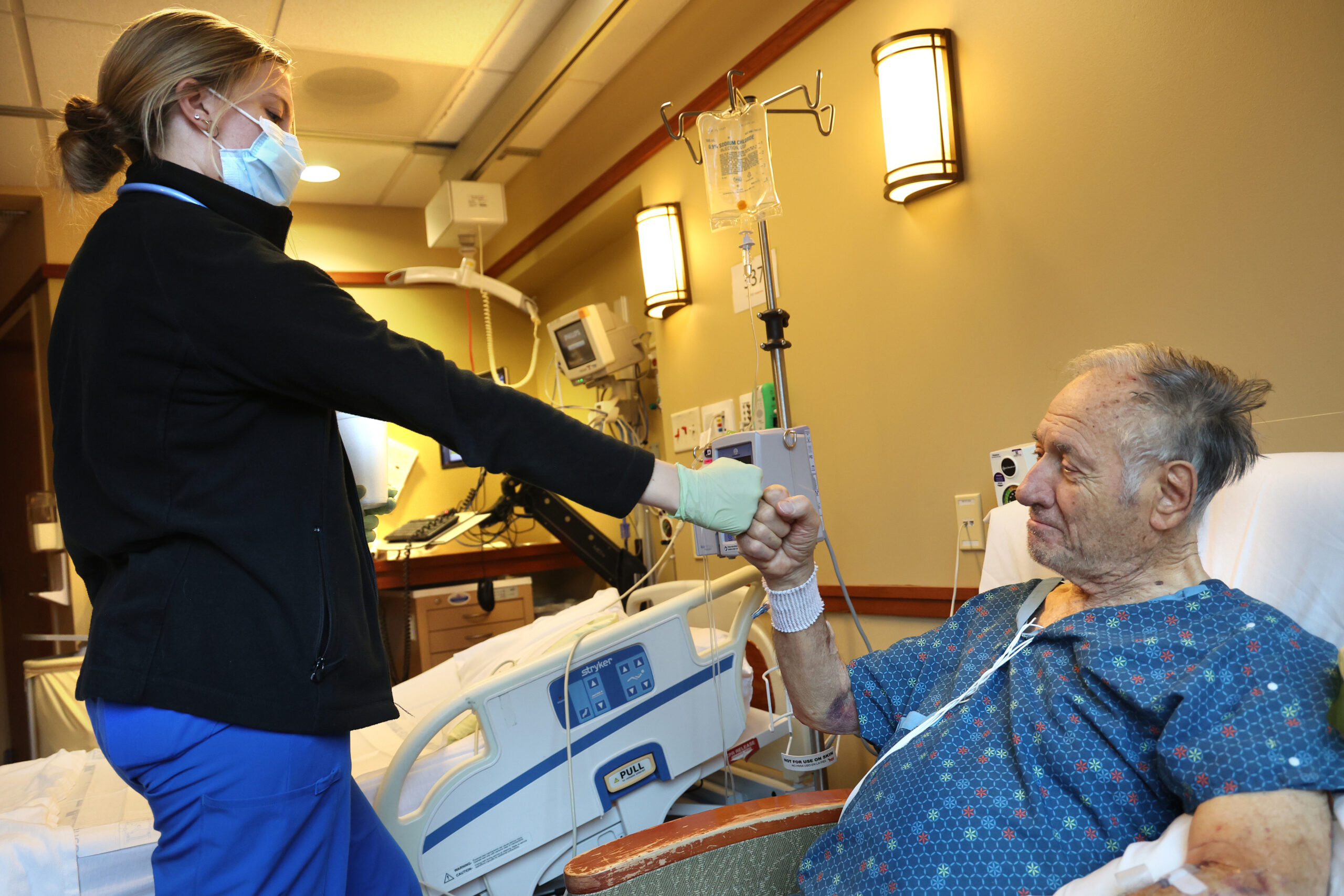 Registered nurse Regan Sauer fist bumps patient Oussama Bayazid after...