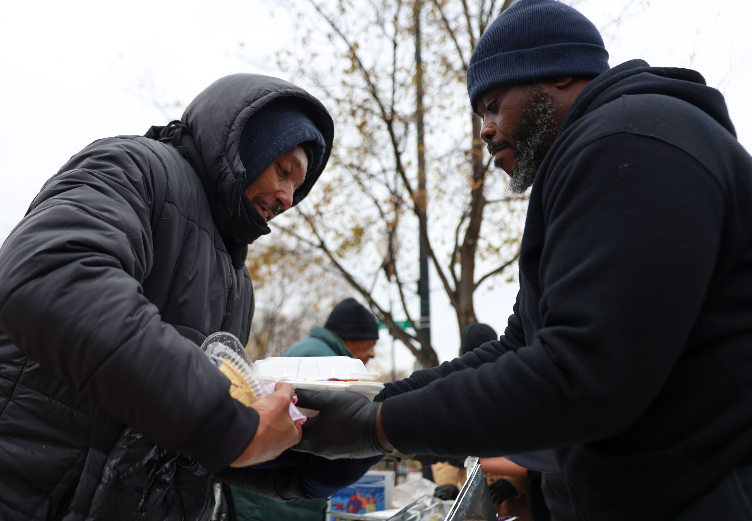 People line up to get a free Thanksgiving dinner served...