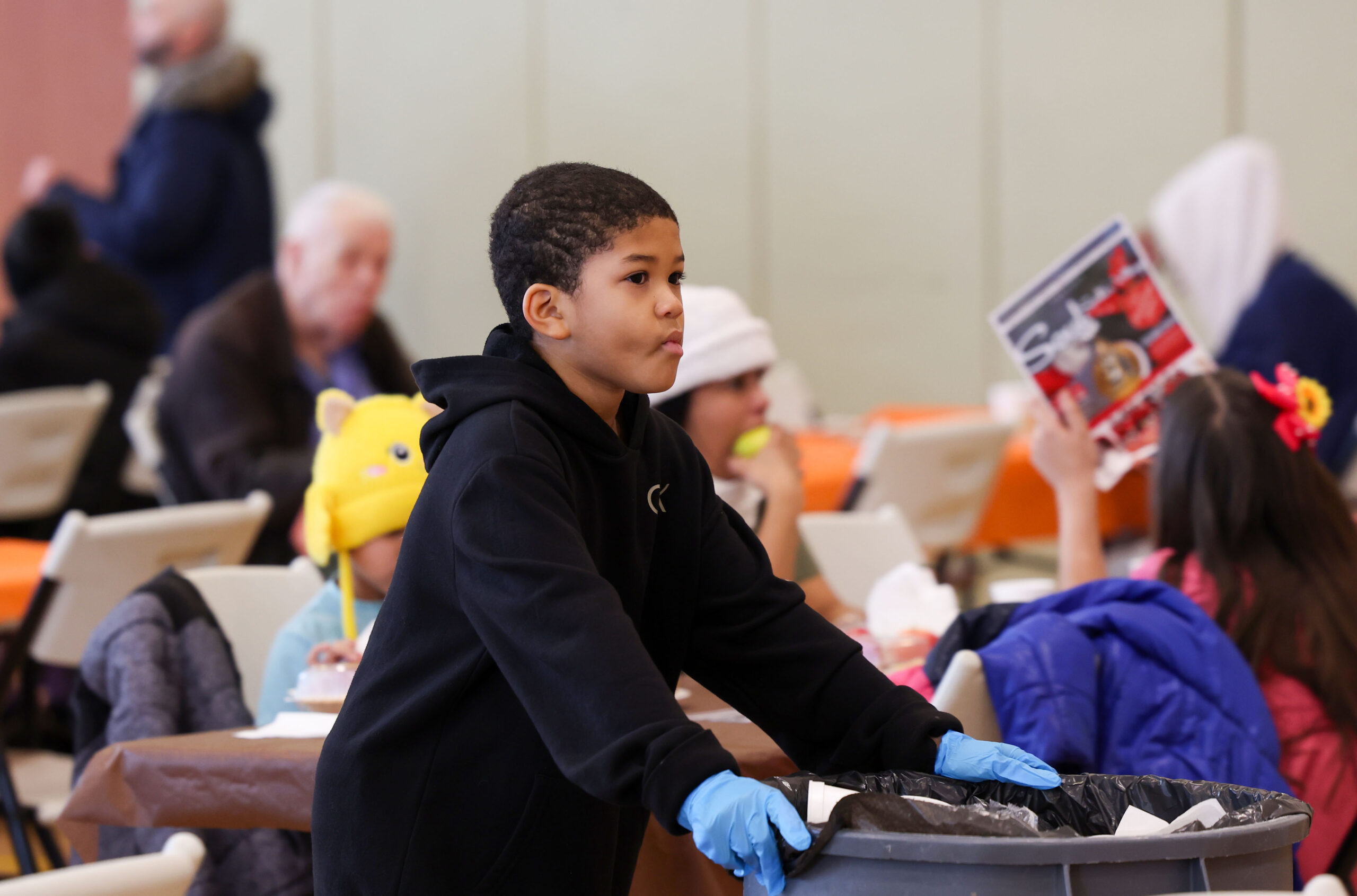 Jionni Victorian, 9, volunteers to clean up after eating a...