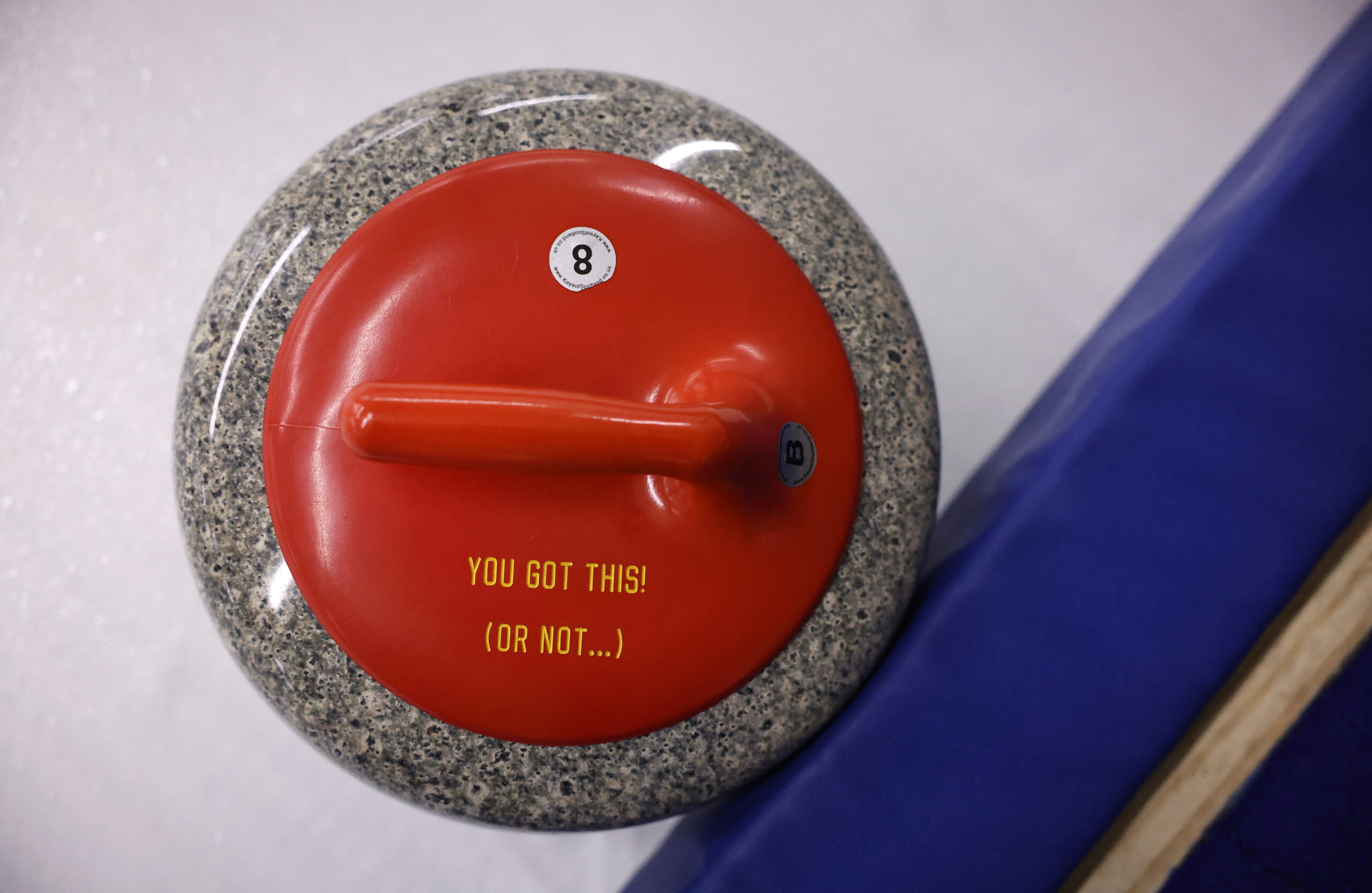 A curling stone holds a message at Windy City Curling...