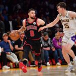 Chicago Bulls guard Zach LaVine (8) moves the ball up court against Los Angeles Lakers guard Austin Reaves (15)