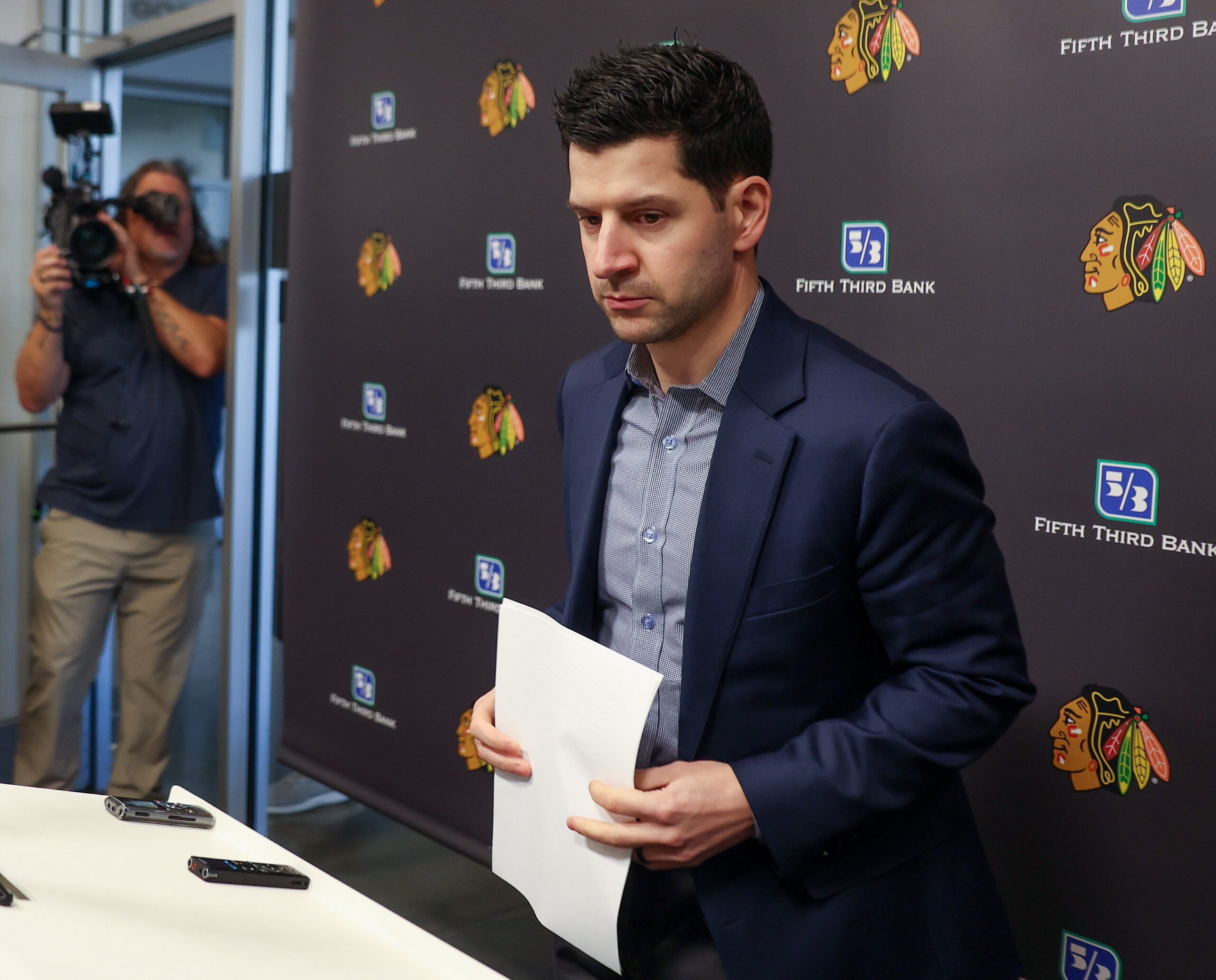 Blackhawks general manager Kyle Davidson speaks with the media following...