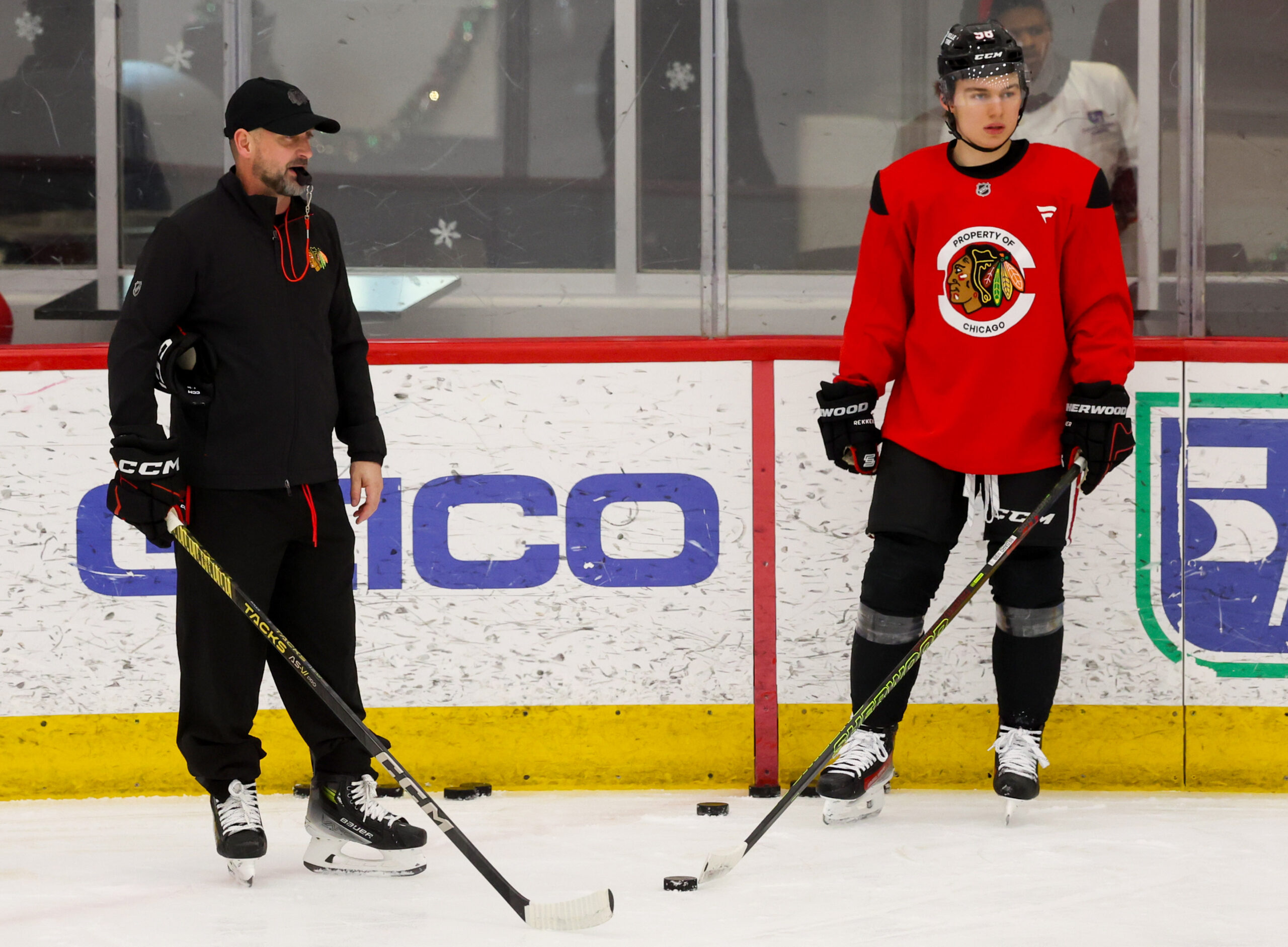 Blackhawks interim head coach Anders Sorensen stands next to center...