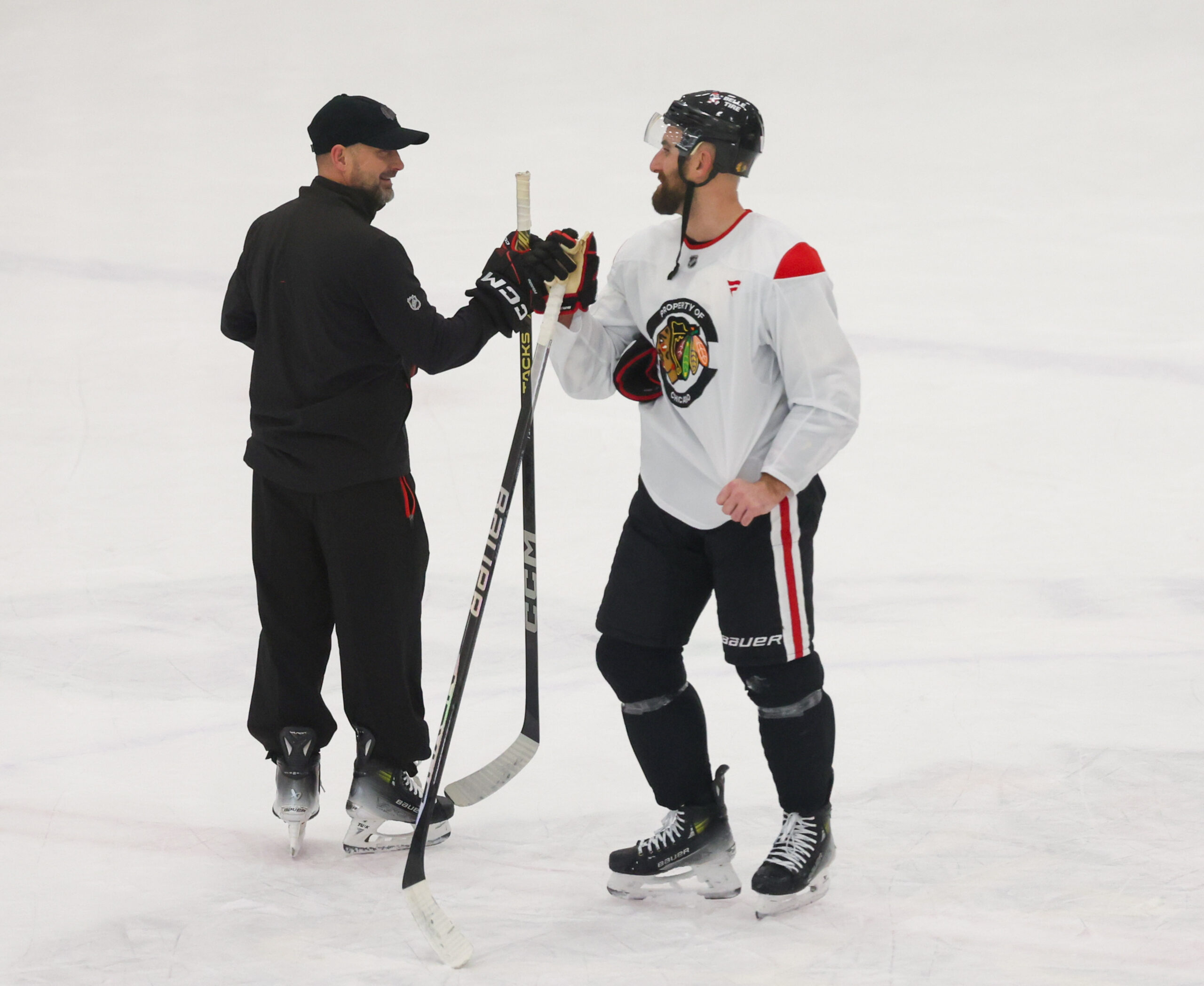 Blackhawks interim head coach Anders Sorensen and captain Nick Foligno...