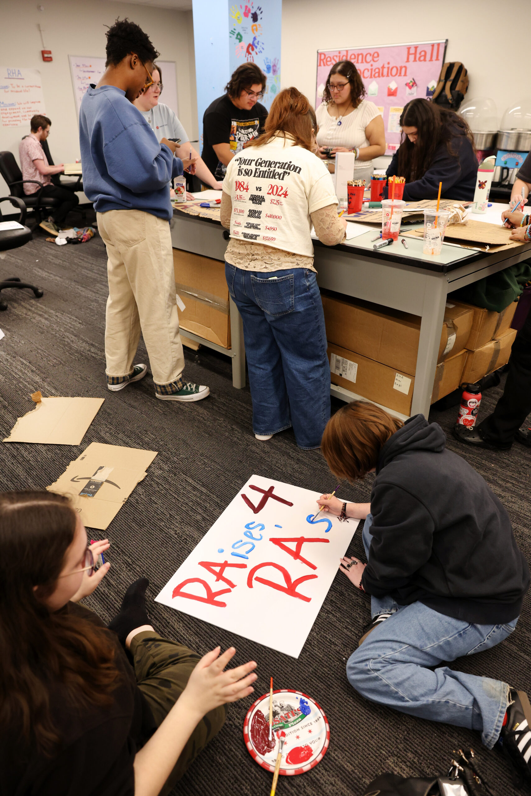 Effie McKinstry, right, creates a poster on Jan. 29, 2025....