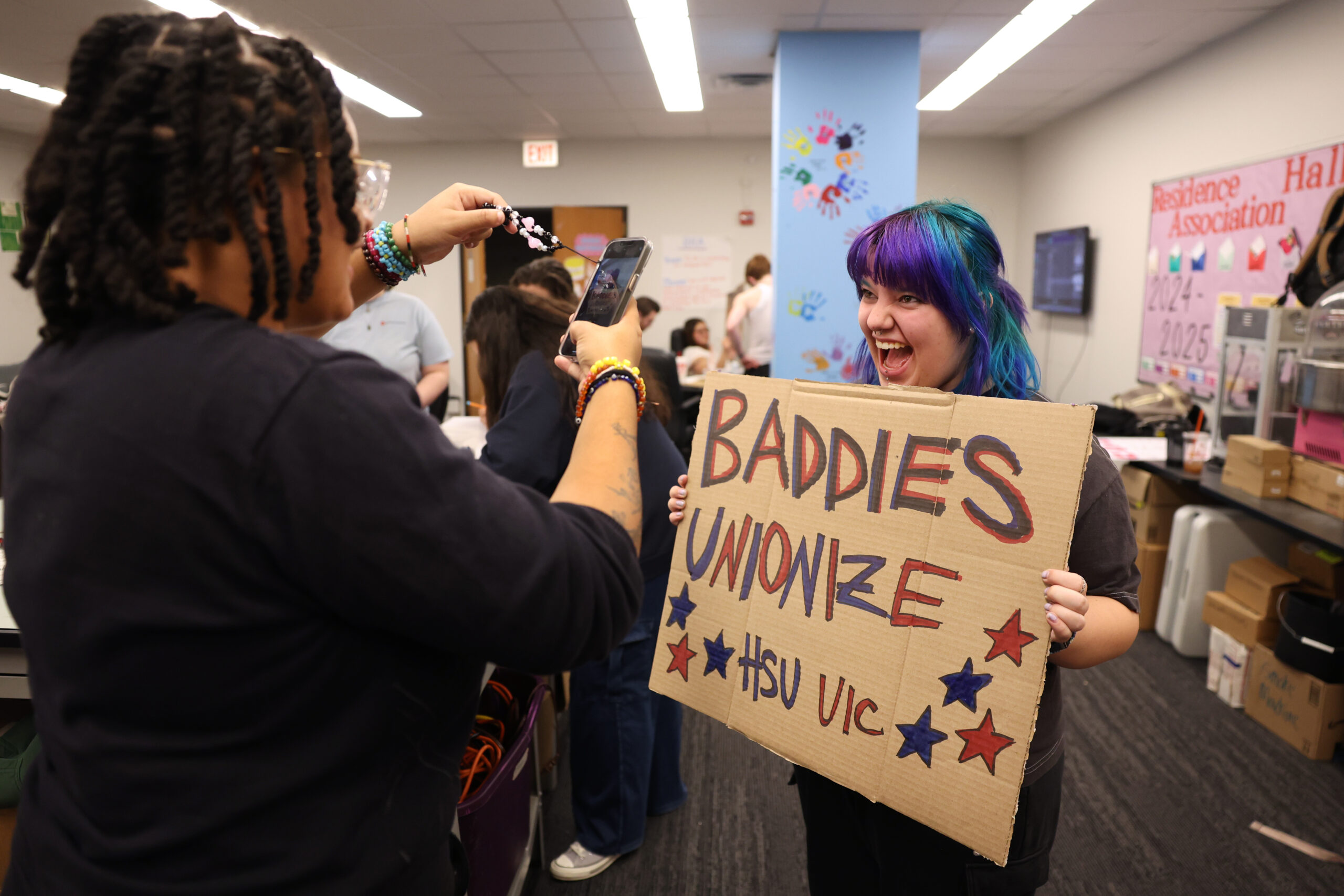 Elisa Hoffman, left, takes a photo of Vic Lind after...