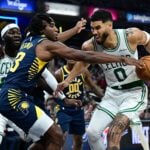 Indiana Pacers forward Aaron Nesmith (23) gets a hand on a ball controlled by Boston Celtics forward Jayson Tatum (0)