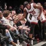 Miami Heat forward Jimmy Butler laughs with Brooklyn Nets fans