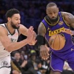 Brooklyn Nets point guard Ben Simmons defends Los Angeles Lakers forward LeBron James