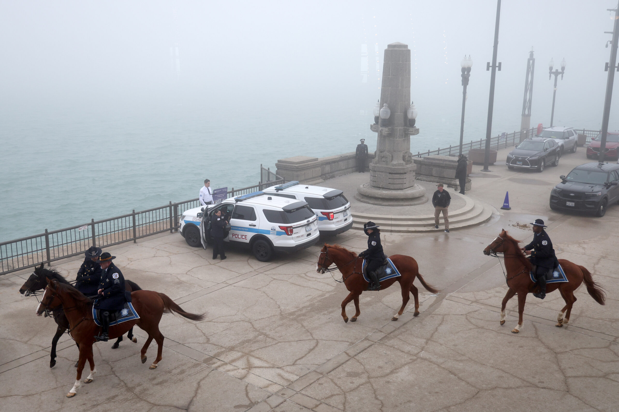 Mounted police officers and their horses leave after the Chicago...