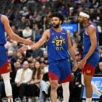 Feb 28, 2025; Detroit, Michigan, USA; Denver Nuggets guard Jamal Murray (27) celebrates with forwards Michael Porter Jr. (1) and Zeke Nnaji (22) after scoring and drawing a foul against the Detroit Pistons in the first quarter at Little Caesars Arena. Mandatory Credit: Lon Horwedel-Imagn Images