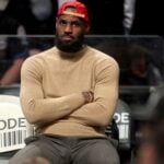 Mar 10, 2025; Brooklyn, New York, USA; Los Angeles Lakers forward LeBron James (23) watches from the bench during the fourth quarter against the Brooklyn Nets at Barclays Center. Mandatory Credit: Brad Penner-Imagn Images