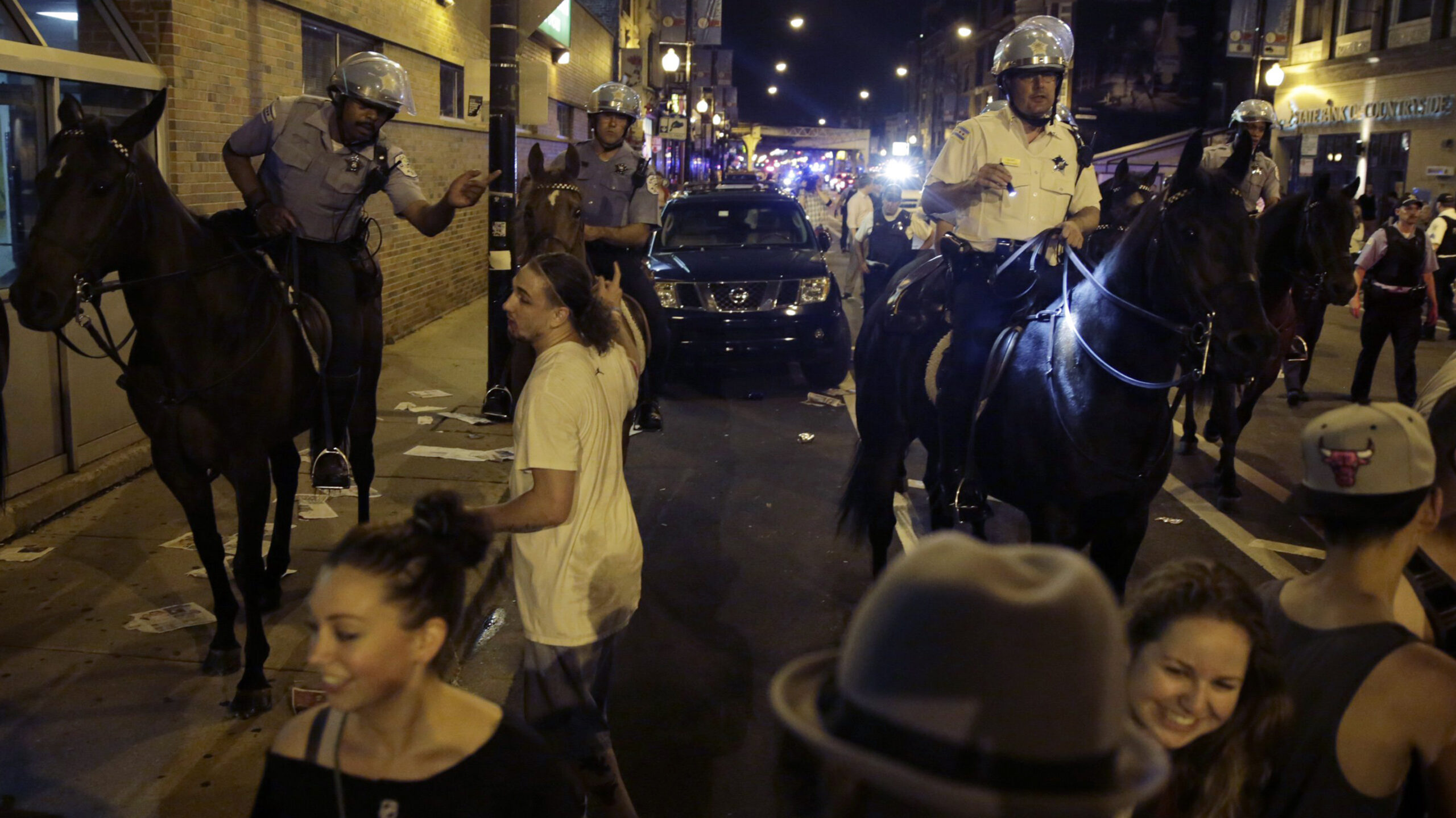 Mounted police officers, including the late Cmdr. Paul Bauer, right,...