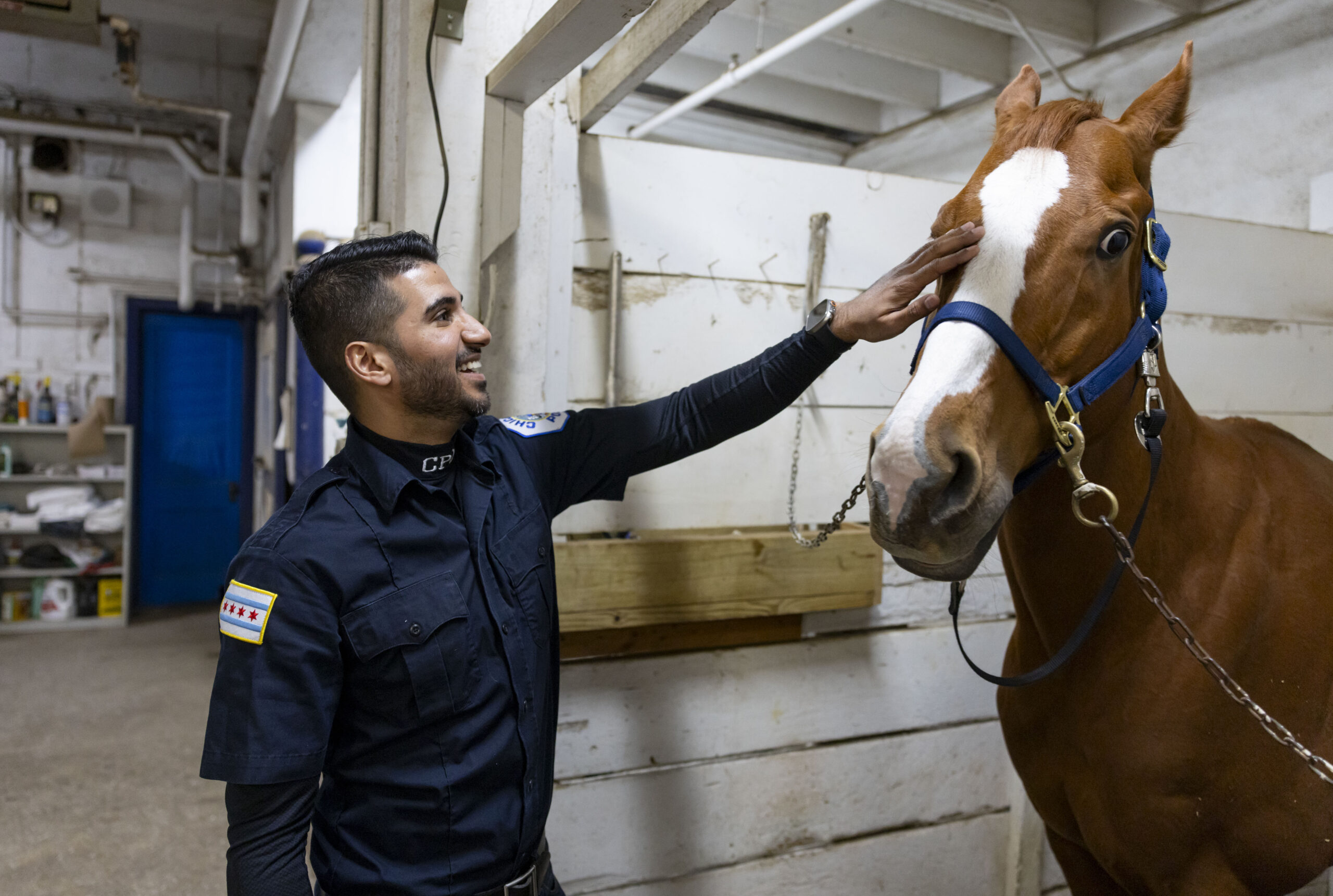 Officer Syed Kazmi pets a horse Feb. 6, 2025, in...