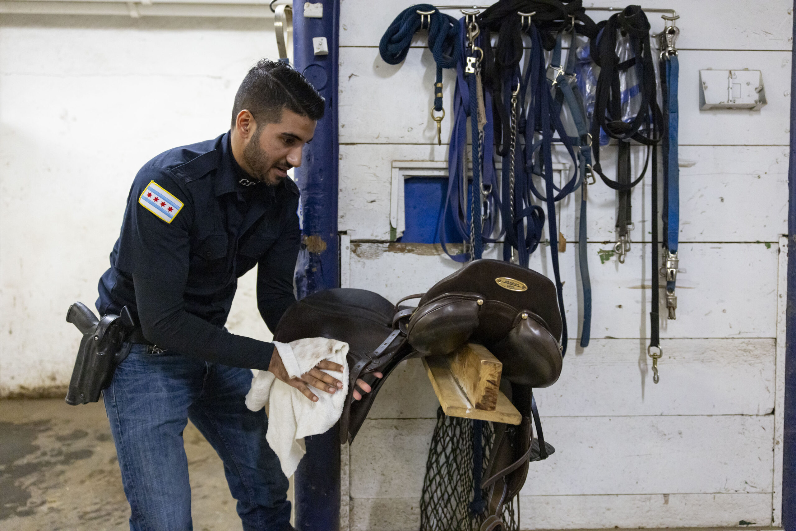 Officer Syed Kazmi washes a saddle on Feb. 6, 2025,...