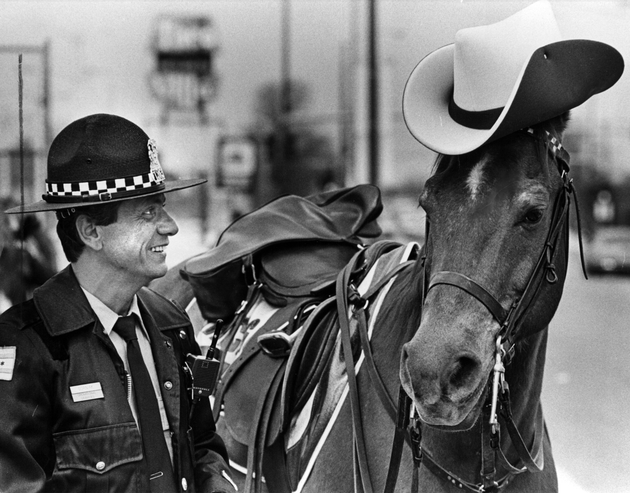 Officer Stan Gorniak checks the fit of the hat on...