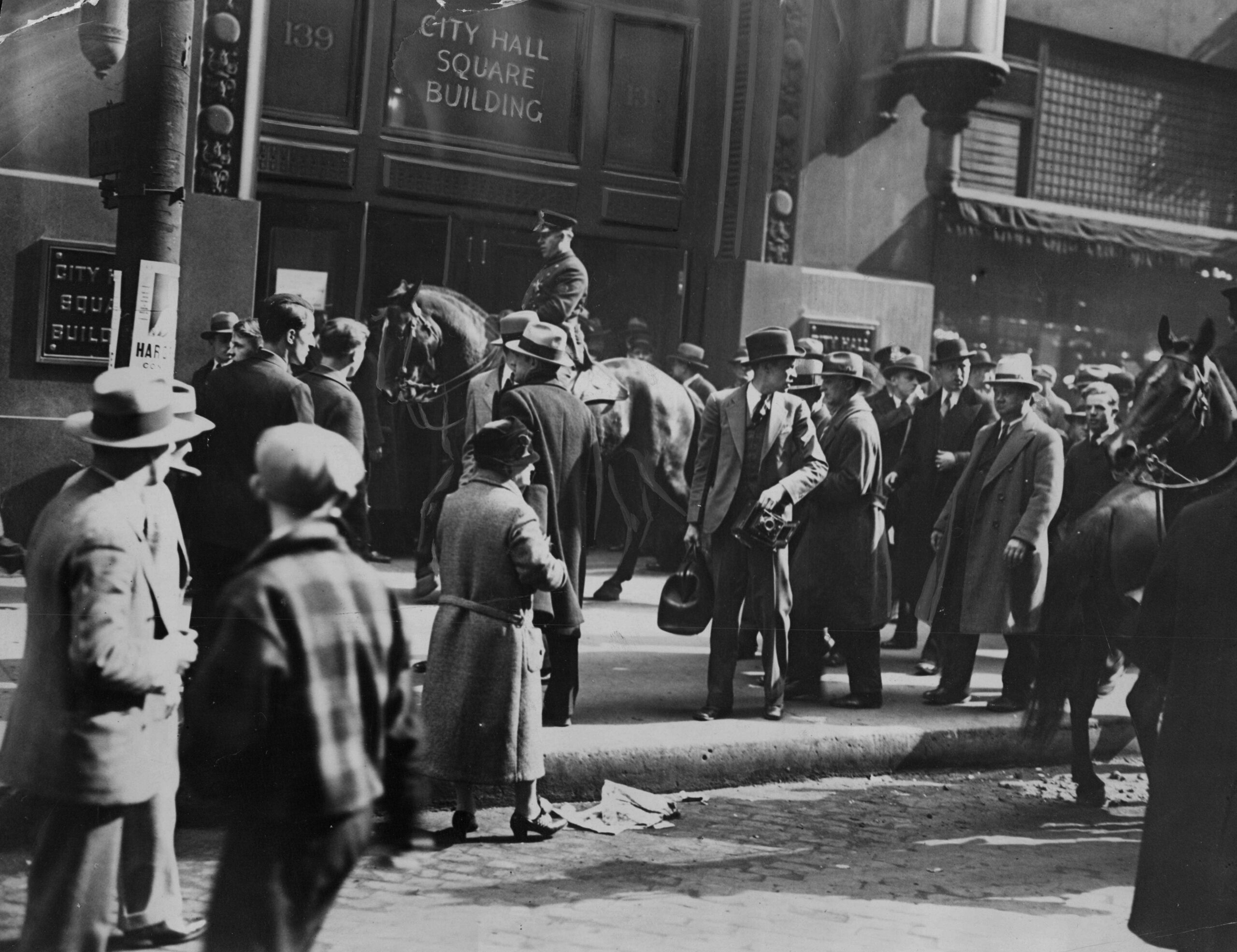 Mounted police patrol the sidewalks in front of the City...